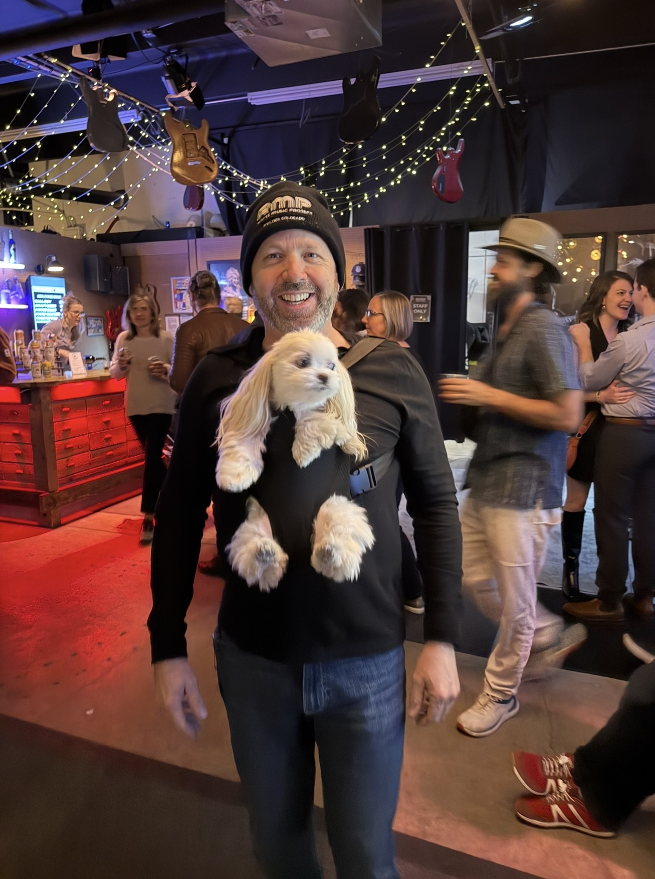Karl — smiling with his dog at a music venue